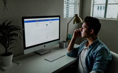 man looking at facebook on a computer